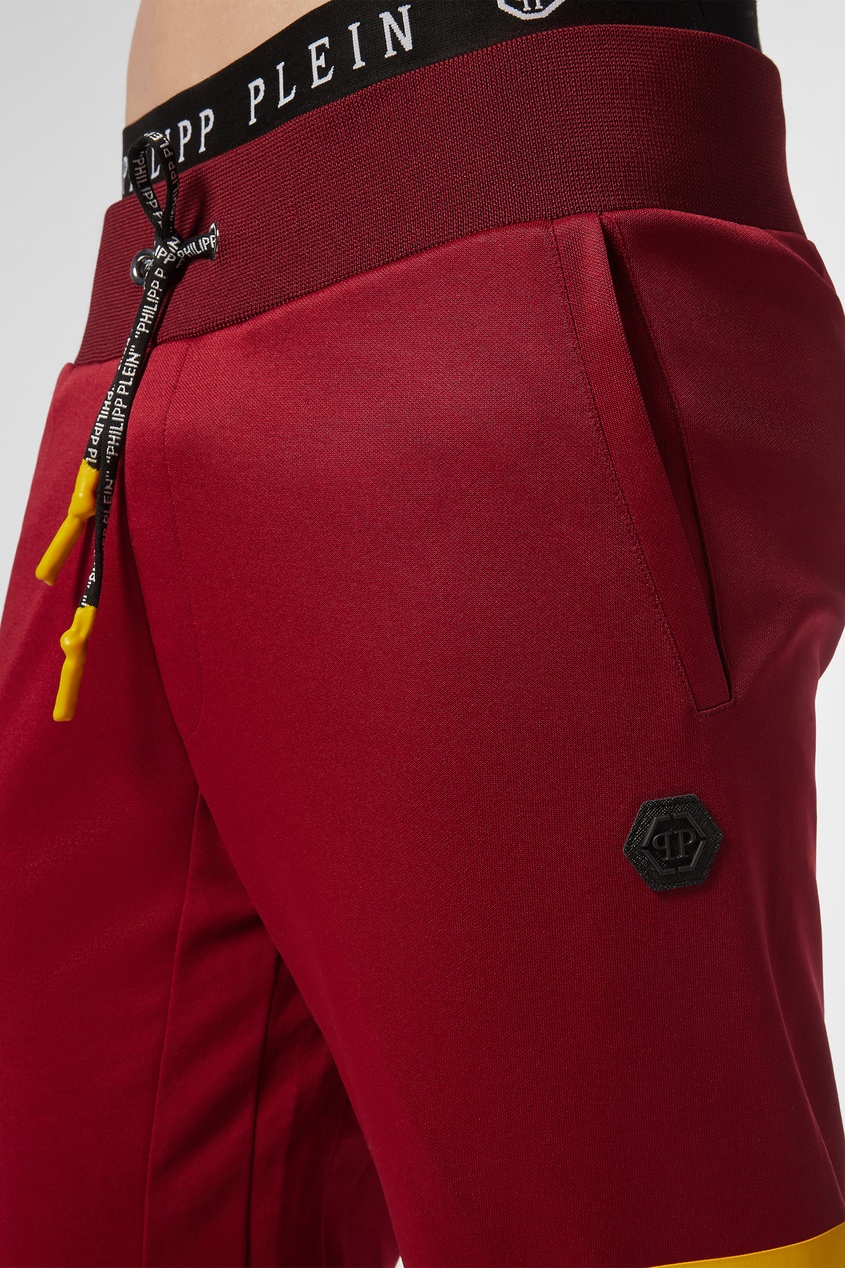 фото Красные брюки с крупными логотипами Philipp plein
