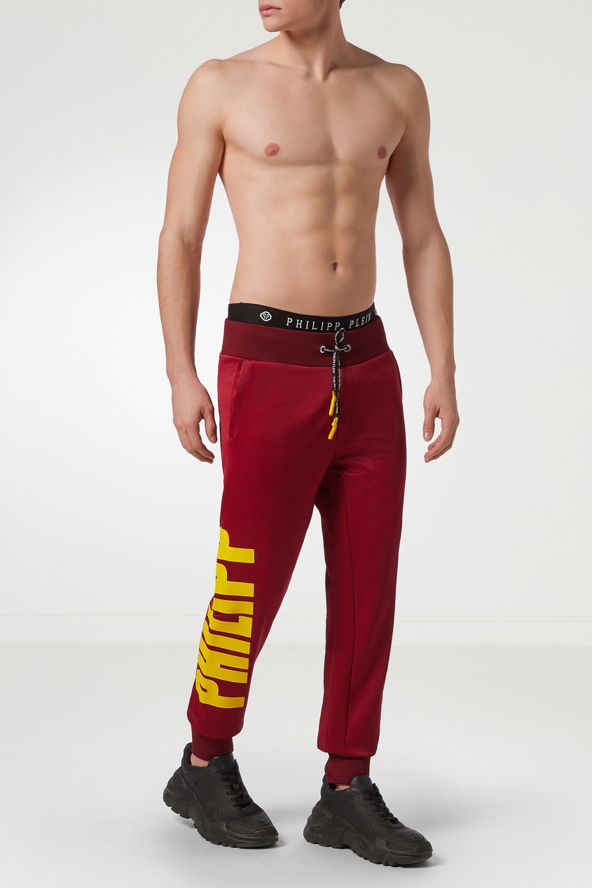 фото Красные брюки с крупными логотипами Philipp plein
